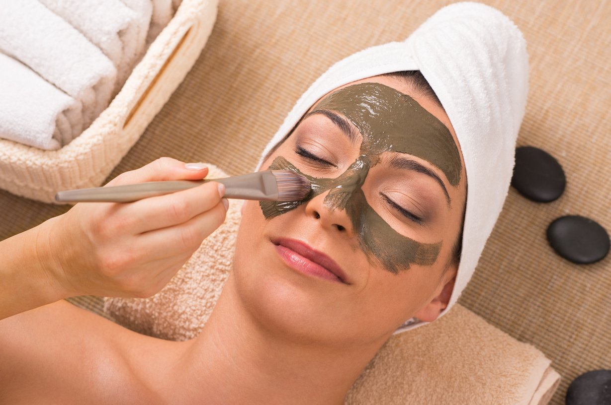 Woman with Green Clay Mask at Spa