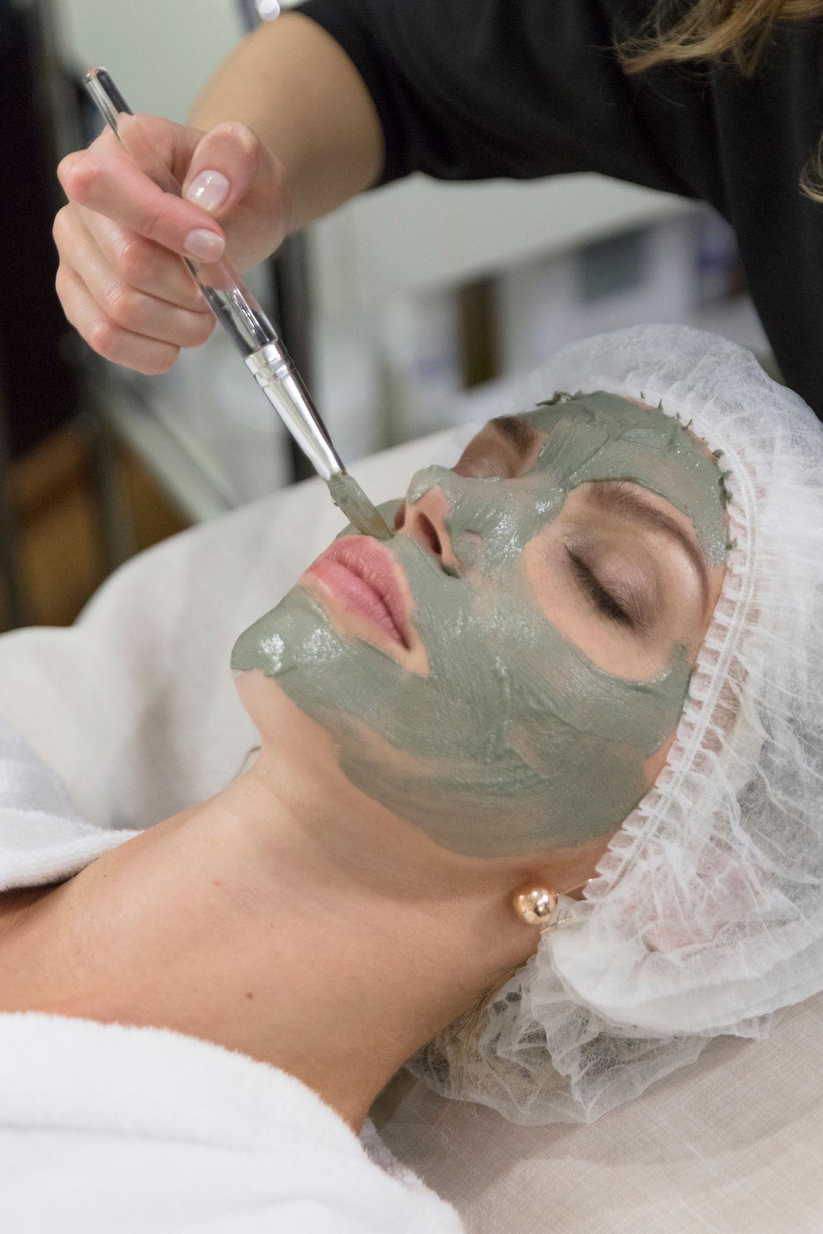 Female Client Receiving Facial Mask in Facial Spa Clinic