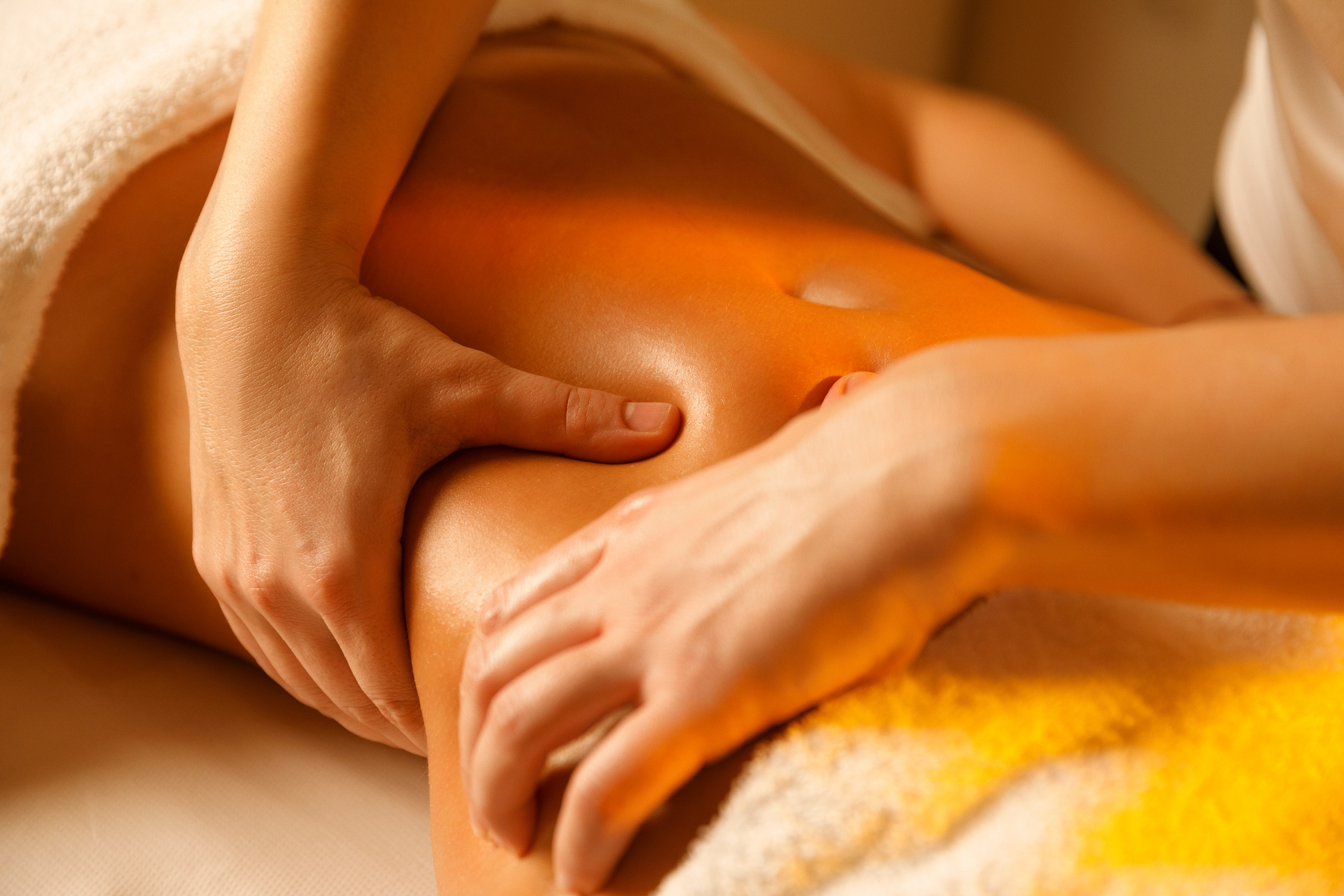 Belly massage Therapist doing healing massage. Woman enjoying in relaxing massaging at health spa treatment. Stomach massage